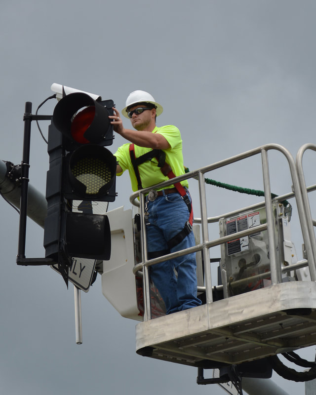 Photo of tech working on traffic light