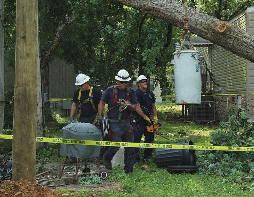 Photo of lineman working on wires after storm