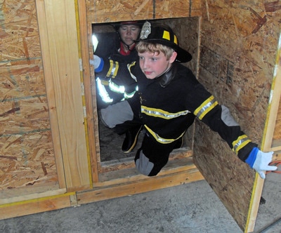 Child in fire fighter's gear